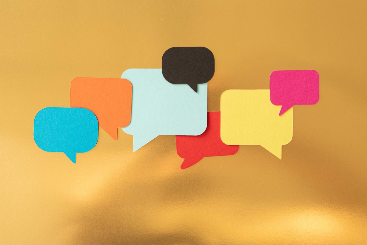 A yellow background with numerous colourful speech bubbles overlapping.